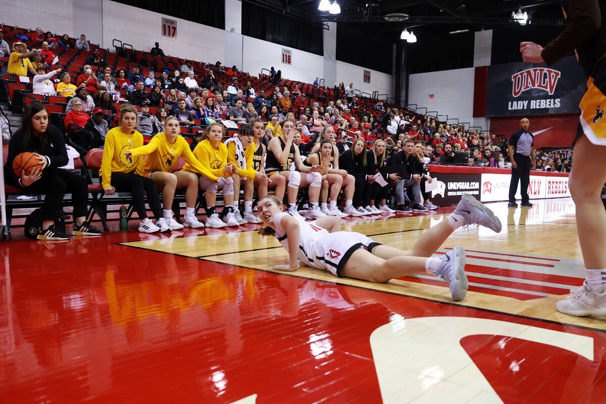 UNLV Lady Rebels guard Ashley Scoggin (0) takes a fall during the first half of a women's baske ...