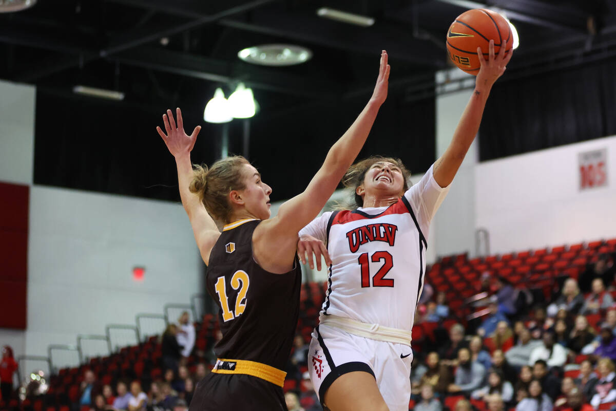 UNLV Lady Rebels guard Alyssa Durazo-Frescas (12) takes a shot under pressure from Wyoming Cowg ...