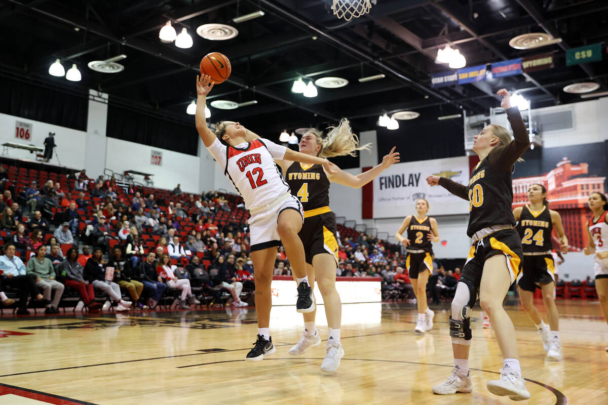 UNLV Lady Rebels guard Alyssa Durazo-Frescas (12) gets her shot blocked by Wyoming Cowgirls for ...
