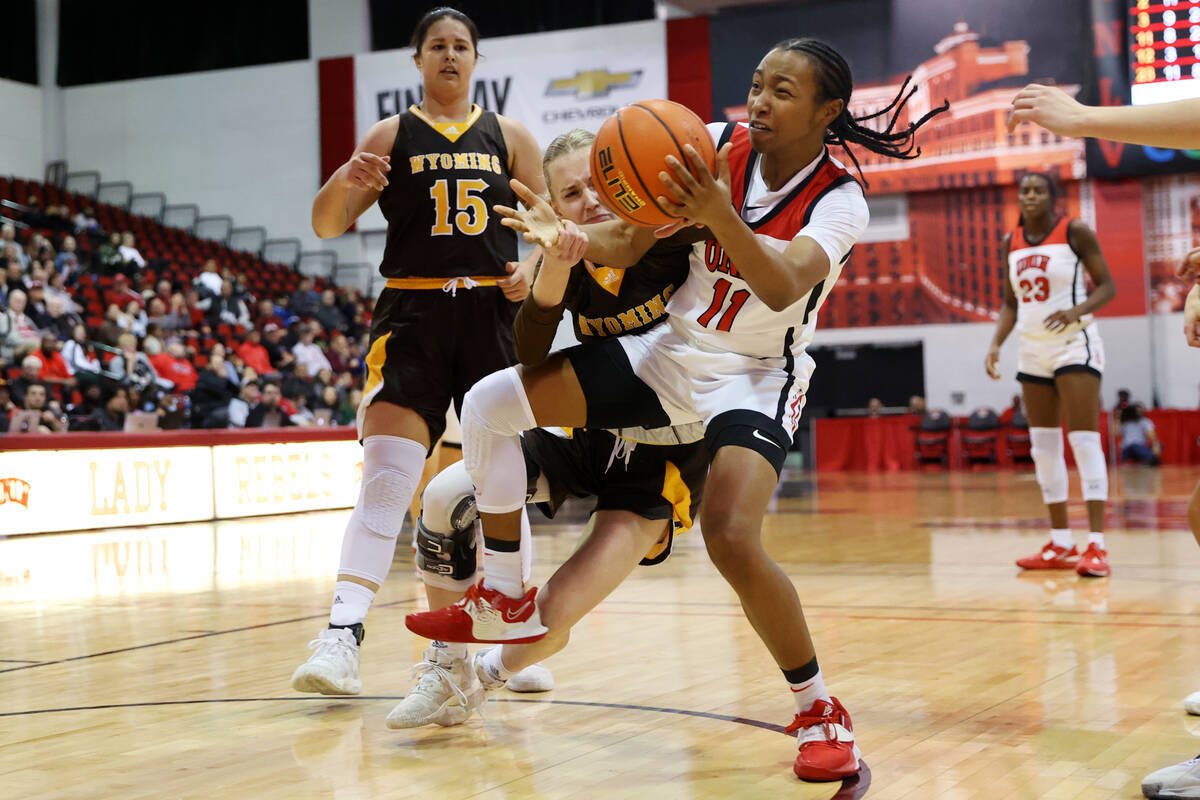 Wyoming Cowgirls guard Ola Ustowska (30) and UNLV Lady Rebels guard Justice Ethridge (11) fight ...