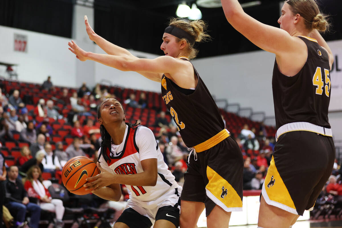 UNLV Lady Rebels guard Justice Ethridge (11) looks for an open shot against Wyoming Cowgirls gu ...