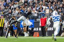 Raiders wide receiver Davante Adams (17) makes a leaping catch with Indianapolis Colts safety R ...