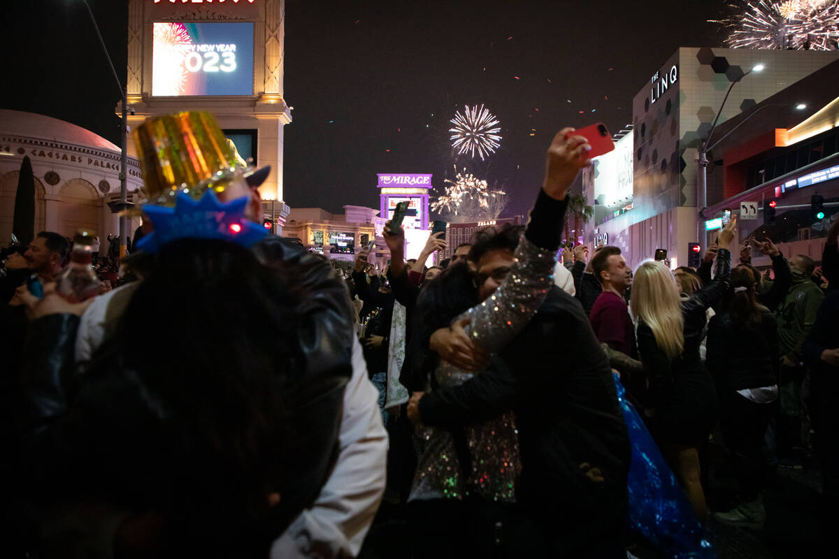 New Year’s Eve revelers watch the fireworks on the Strip on Saturday, Dec. 31, 2022, in Las V ...