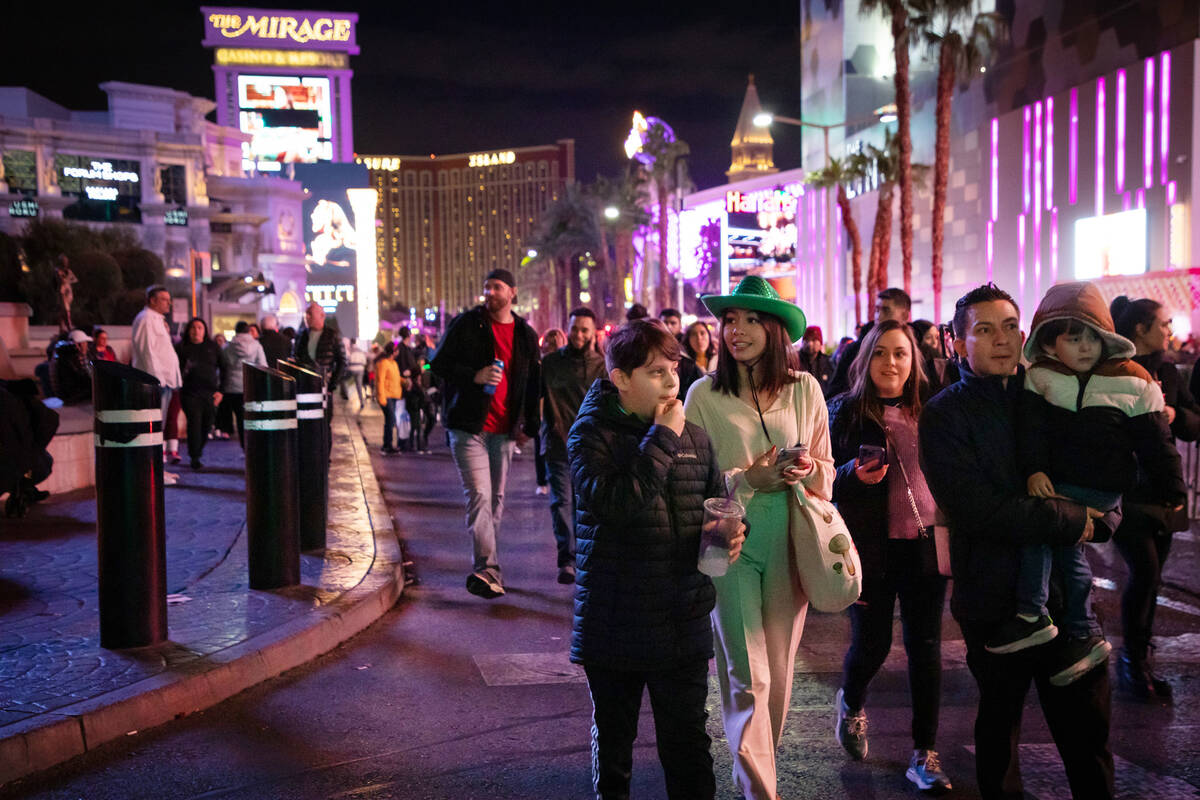 New Year’s Eve revelers walk down the Strip on Saturday, Dec. 31, 2022, at her home in Las Ve ...