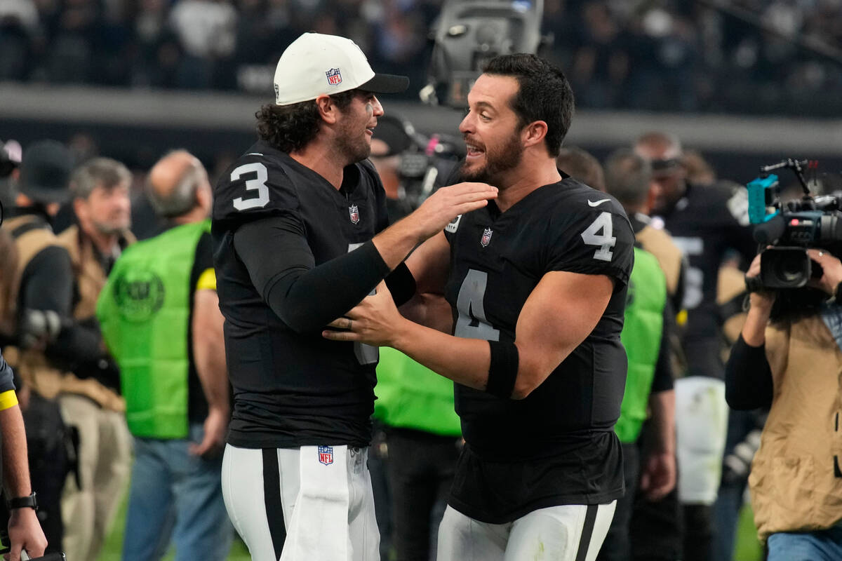 Las Vegas Raiders quarterback Jarrett Stidham (3) and quarterback Derek Carr (4) leave the fiel ...