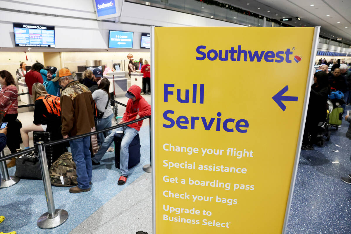 Passengers wait in line at the Southwest ticket counter in Terminal 1 at Harry Reid Internation ...