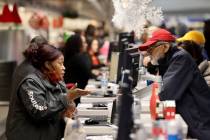 Agents help passengers at the Southwest ticket counter in Terminal 1 at Harry Reid Internationa ...