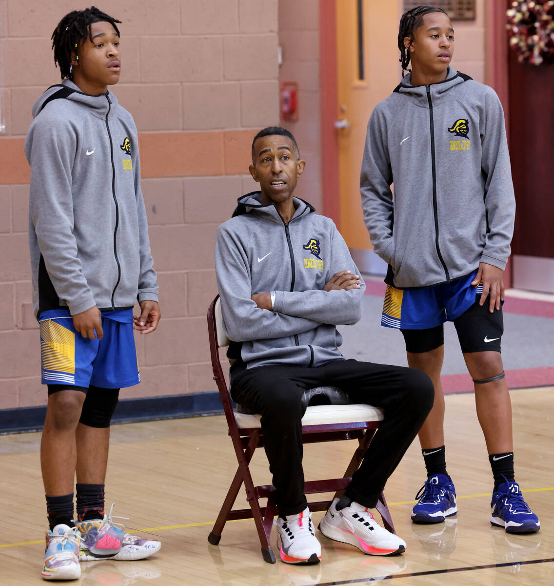 Democracy Prep assistant coach Mark Coleman talks to his sons Tru Coleman, left, and Tai Colema ...