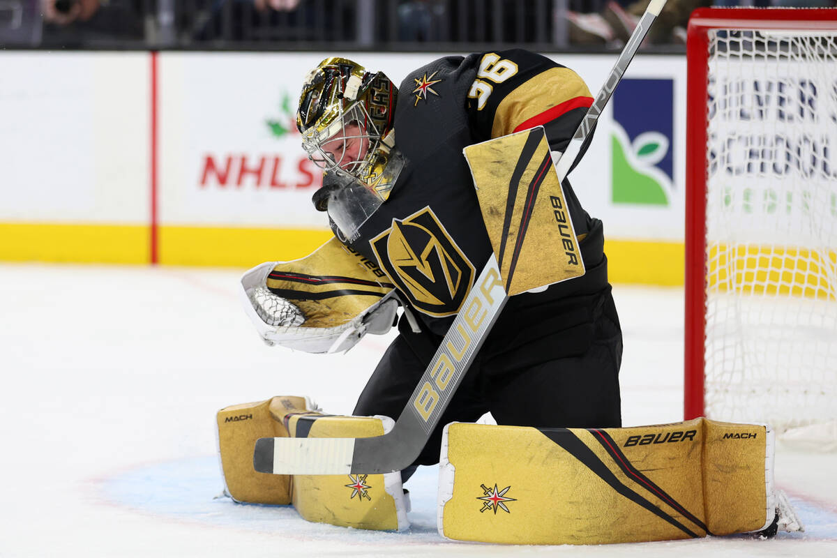 Vegas Golden Knights goaltender Logan Thompson (36) takes a shot to the face during the second ...
