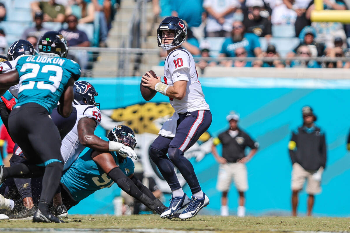 Houston Texans quarterback Davis Mills (10) looks for a receiver during an NFL football game ag ...