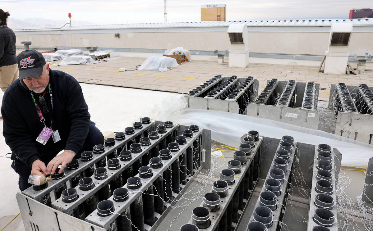 Fireworks by Grucci pyro technician Michael Wassmer loads pyrotechnics on the roof of The Venet ...