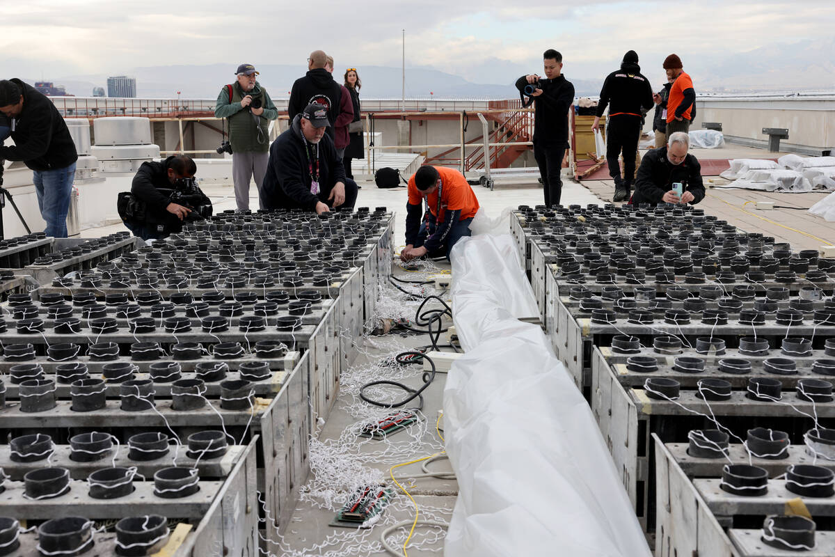 Technicians with Fireworks by Grucci, including Michael Wassmer, left, and Tom Pilato, pyrotech ...