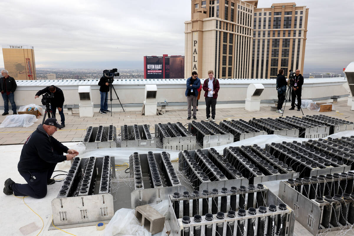 Fireworks by Grucci pyro technician Michael Wassmer loads pyrotechnics on the roof of The Venet ...