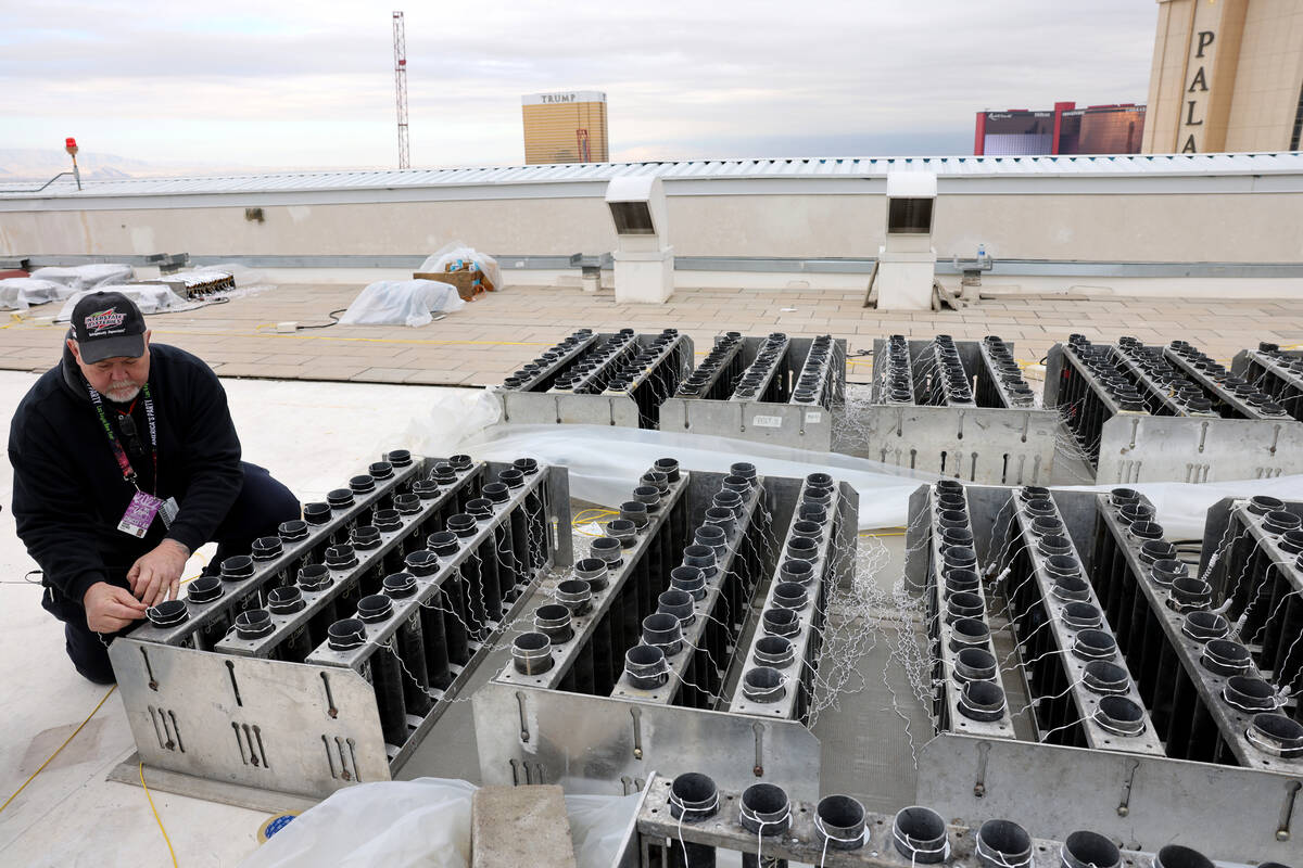Fireworks by Grucci pyro technician Michael Wassmer loads pyrotechnics on the roof of The Venet ...