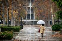 Umbrellas come out near the Van Nuys, Calif., courthouse as rain begins to fall Tuesday, Dec. 2 ...