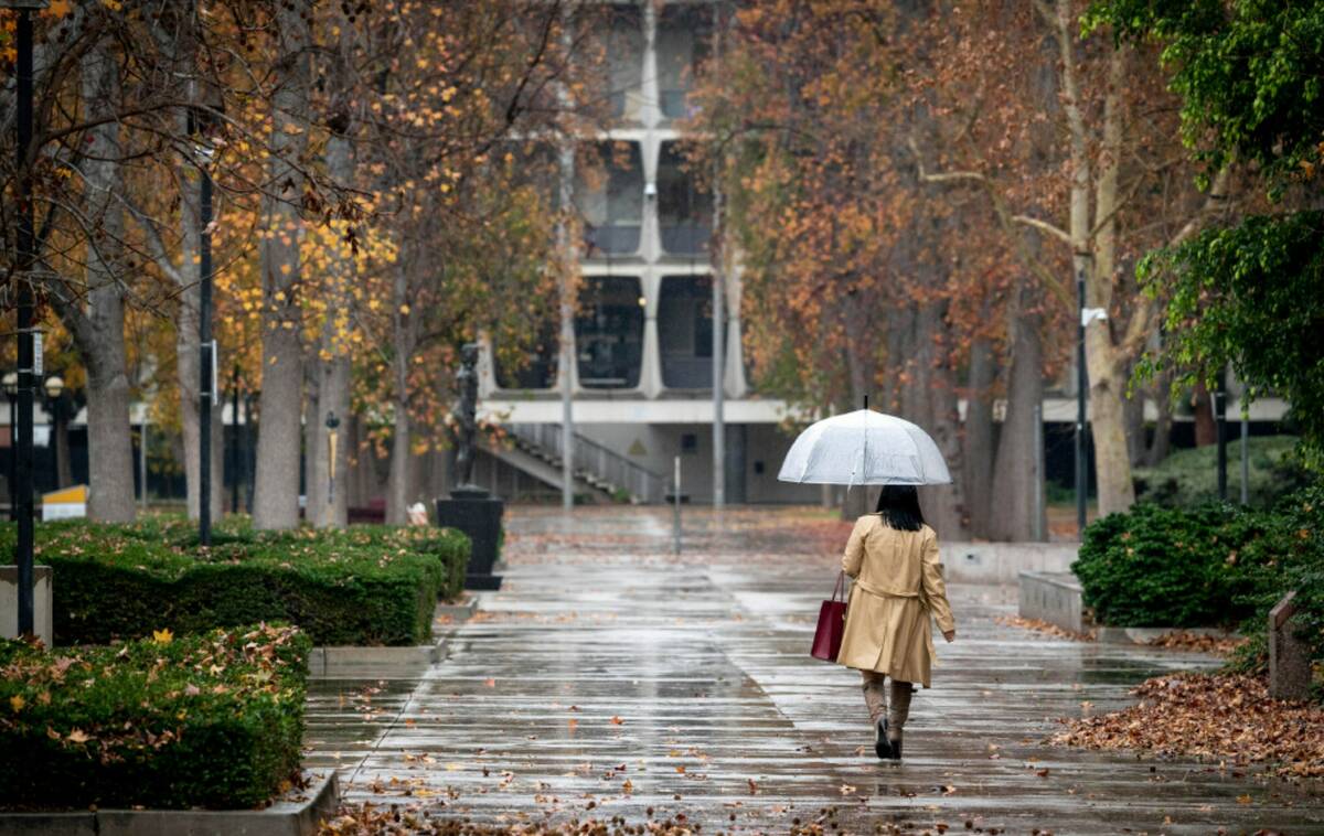 Umbrellas come out near the Van Nuys, Calif., courthouse as rain begins to fall Tuesday, Dec. 2 ...