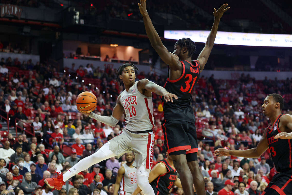 UNLV Rebels guard Keshon Gilbert (10) makes a pass behind the back of San Diego State Aztecs fo ...