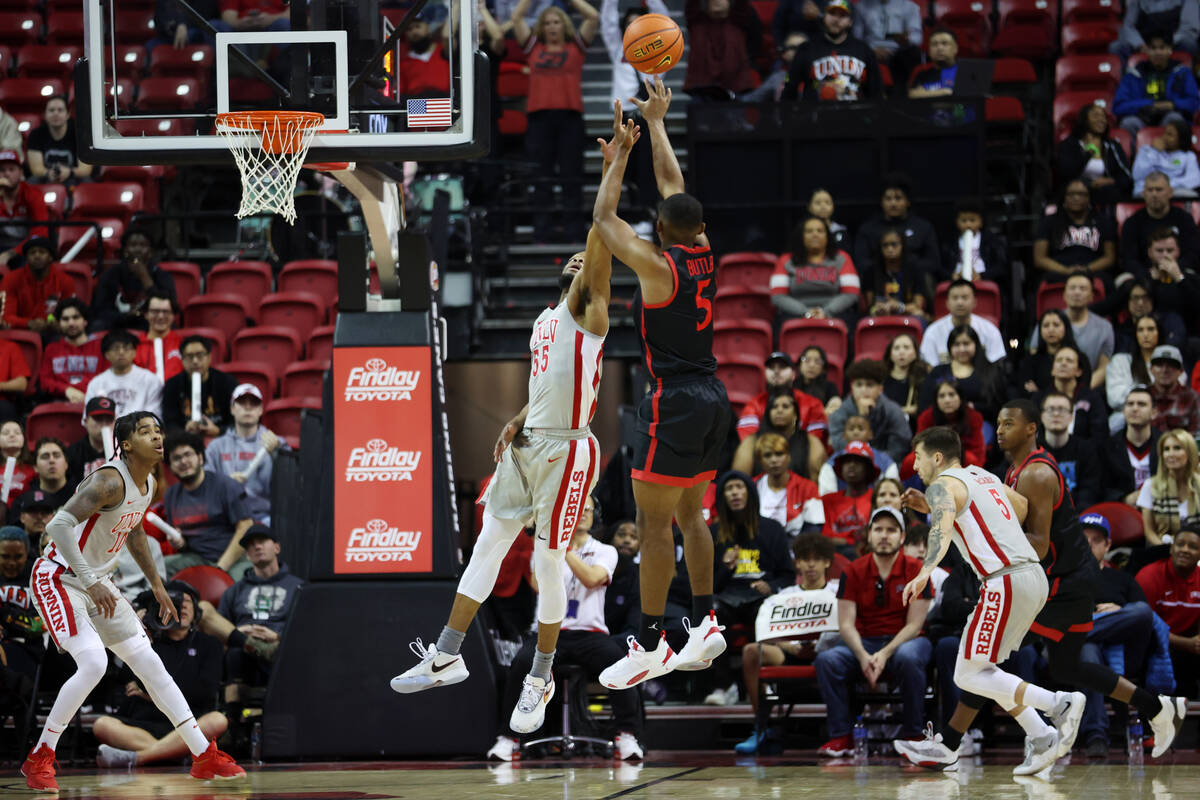 UNLV Rebels guard EJ Harkless (55) defends a shot by San Diego State Aztecs guard Lamont Butler ...