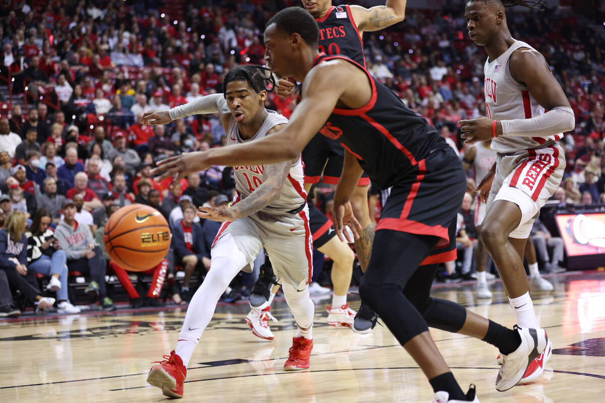 UNLV Rebels guard Keshon Gilbert (10) and San Diego State Aztecs guard Micah Parrish (3) fight ...