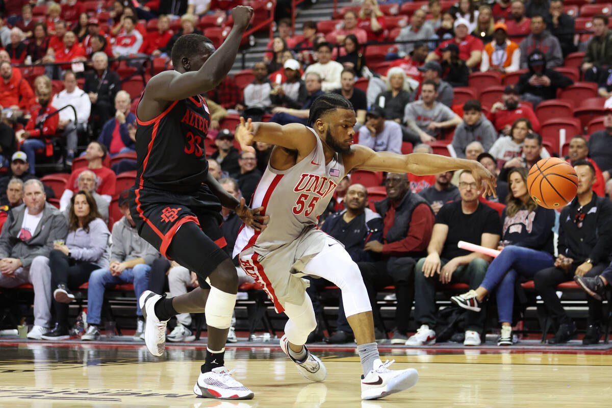 UNLV Rebels guard EJ Harkless (55) loses the ball under pressure from San Diego State Aztecs fo ...