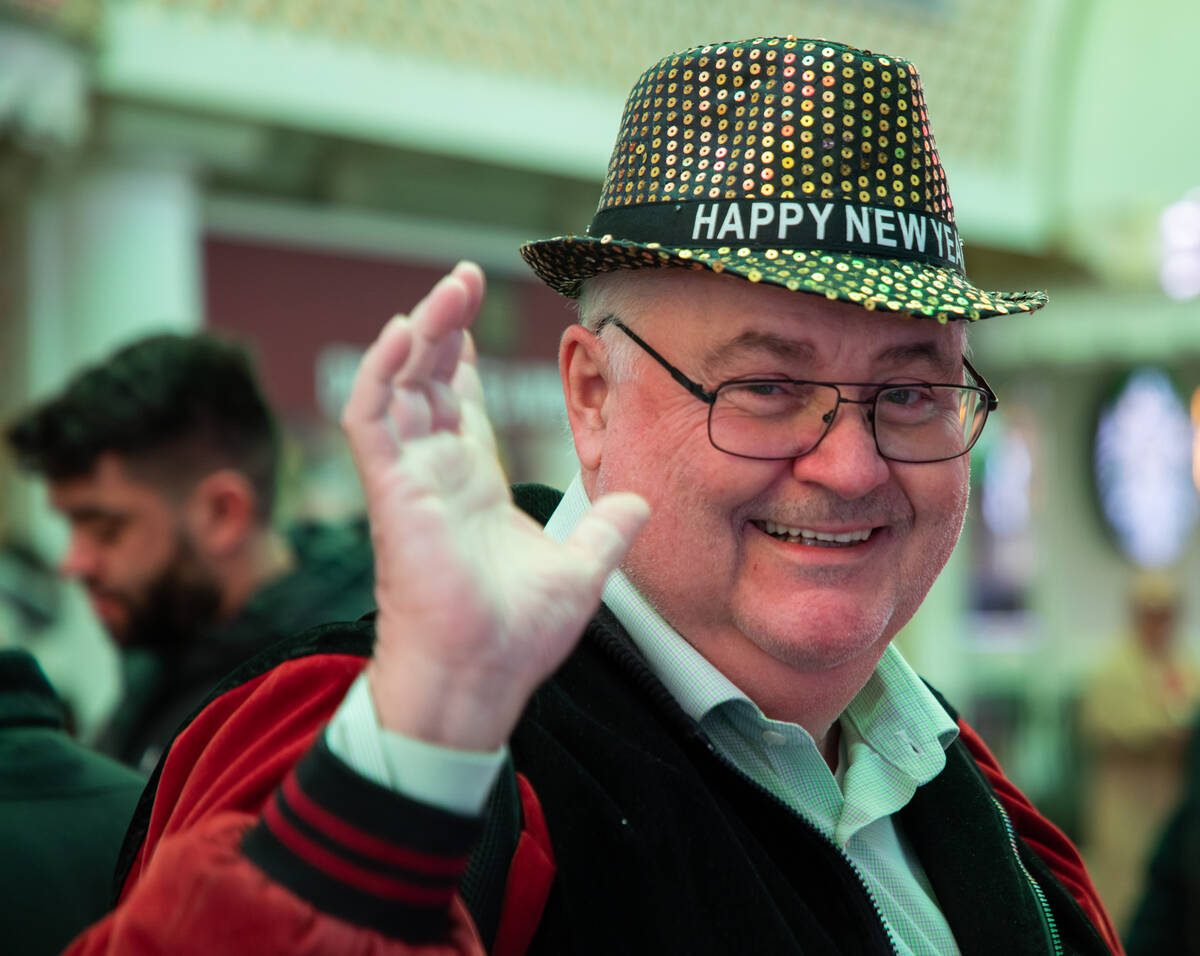 Denis Lebel, 66, of Quebec, Canada, waves while trying on his new hat on Saturday, Dec. 31, 202 ...