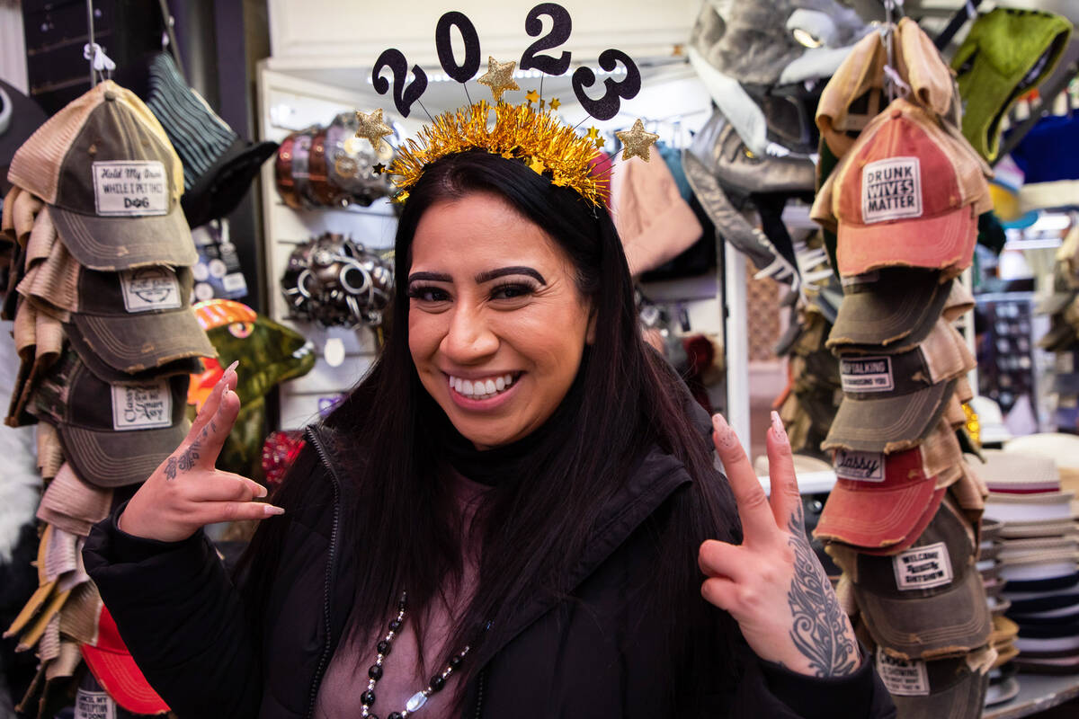 Wendy Boyas, of California, poses for a photo with her New Year’s Eve headband on Saturd ...