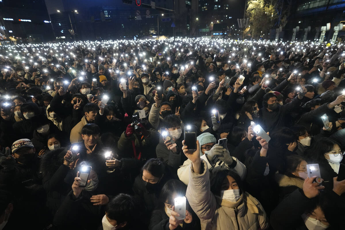 People light up their smartphones as they celebrate the New Year's eve in front of the Bosingak ...