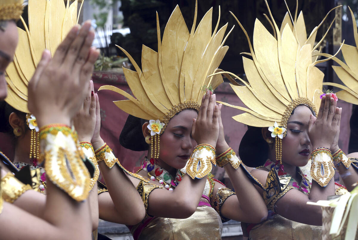 Women dancers pray before their perform during culture parade to bid farewell to 2022 and welco ...