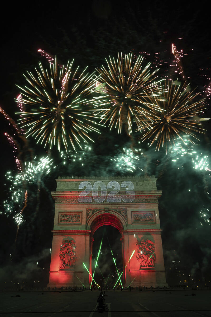 A sound and light show is projected on the Arc de Triomphe during New Year celebrations on the ...