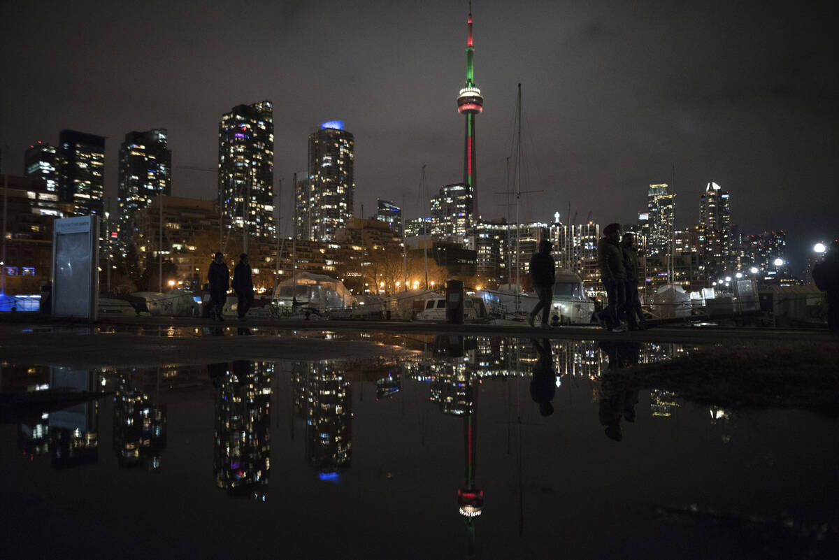 People make their way along the lakeshore ahead of the New Year's fireworks display over Toront ...