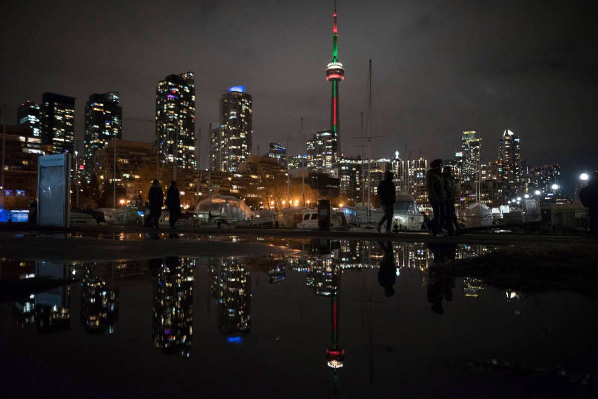 People make their way along the lakeshore ahead of the New Year's fireworks display over Toront ...