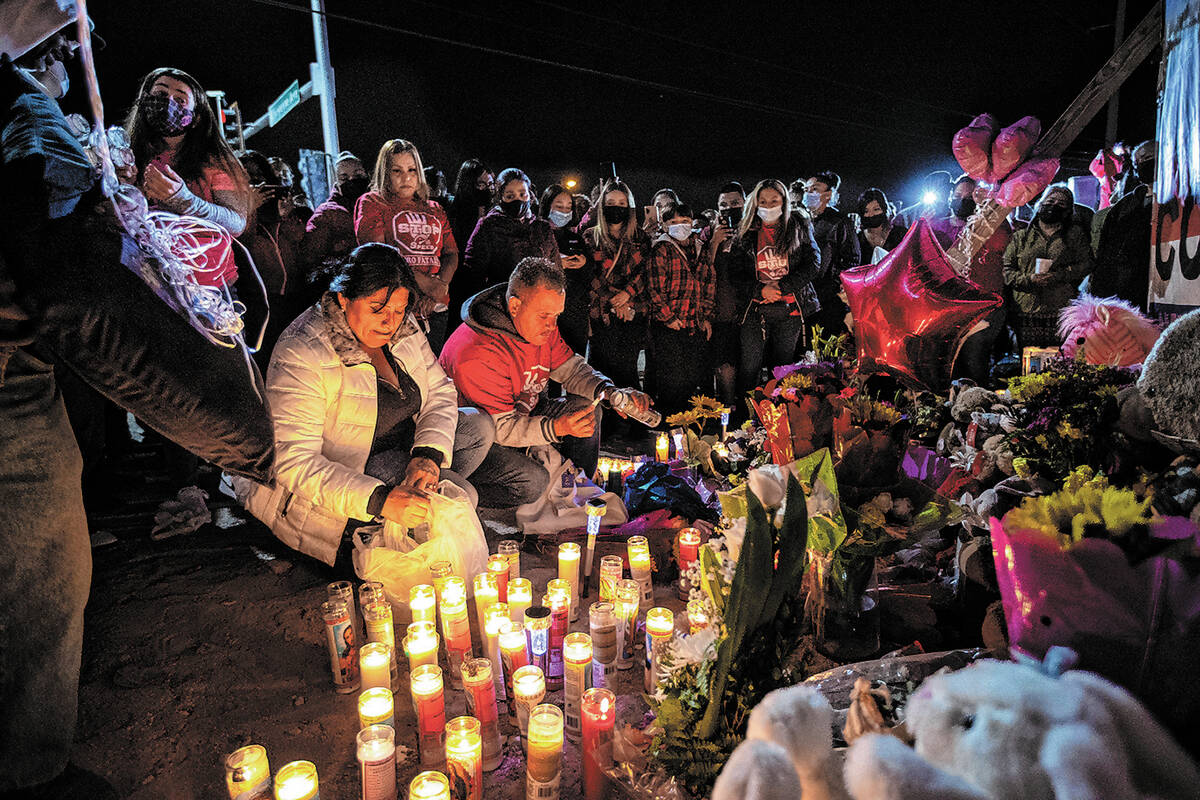 Erlinda Zacarias, left, and husband Jesus Mejia-Santana, light candles during a vigil on Feb. 5 ...