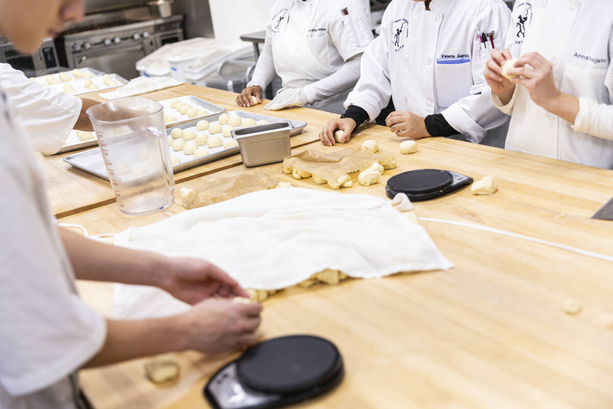 Southeast Career Technical Academy culinary students prepare bread rolls in the kitchen on Tues ...