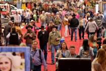 Shoppers browse booths during Cowboy Christmas at the Las Vegas Convention Center Thursday, Dec ...