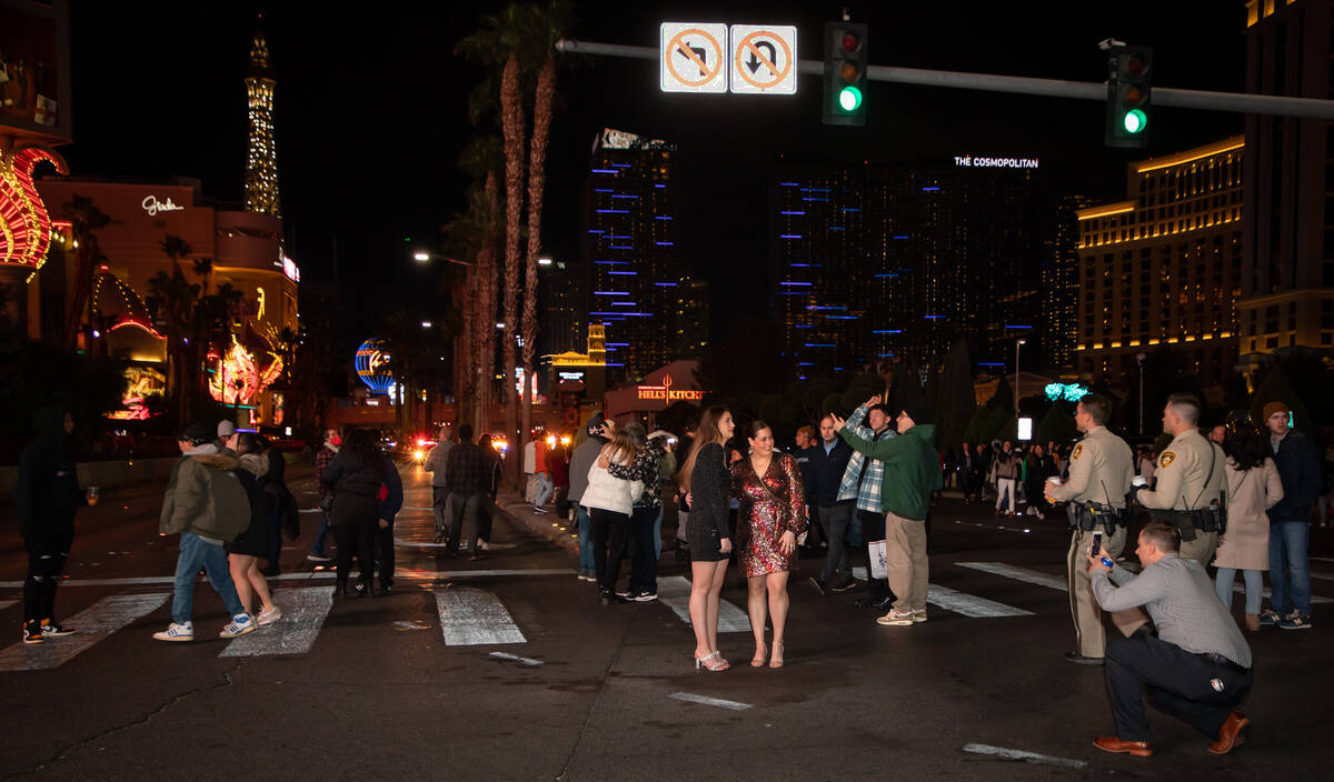 New Year’s Eve revelers walk down the Strip on Saturday, Dec. 31, 2022, in Las Vegas. (Amaya ...