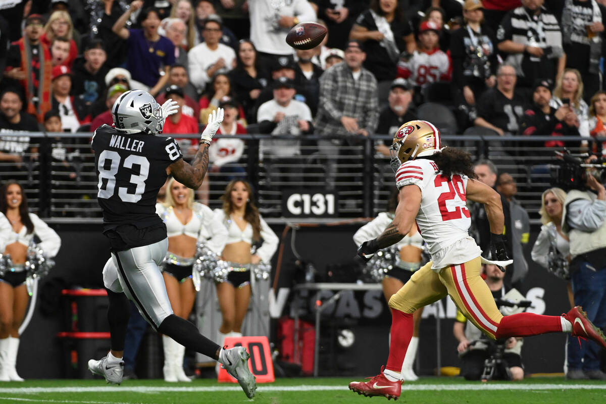 Las Vegas Raiders tight end Darren Waller (83) catches a 24-yard touchdown pass while being def ...