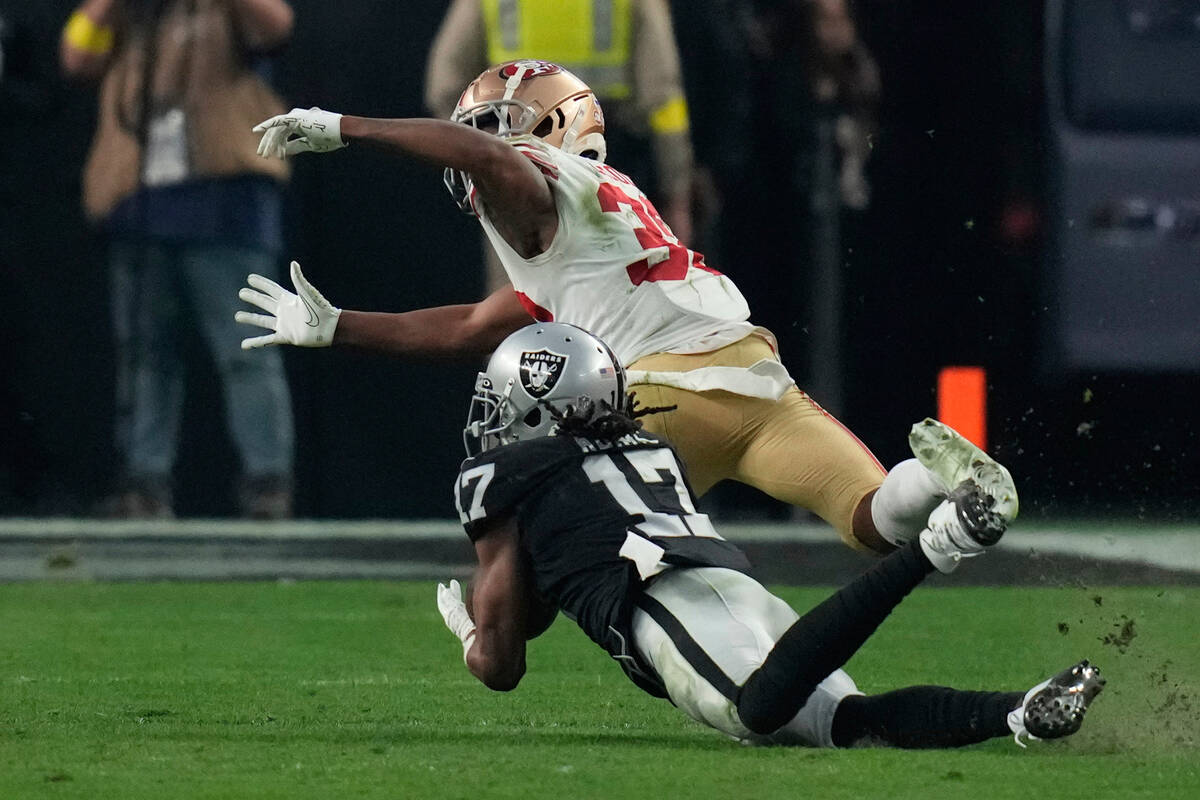 Las Vegas Raiders wide receiver Davante Adams (17) catches a pass while being defended by San F ...