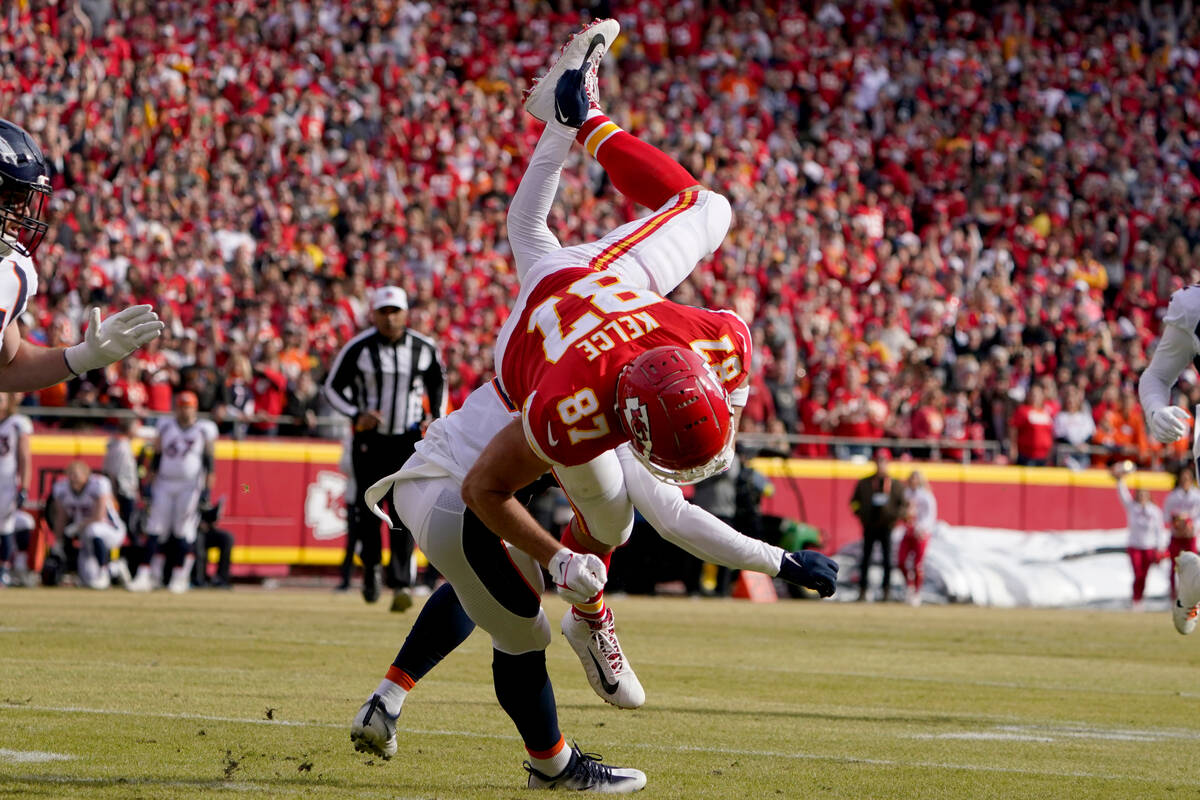 Kansas City Chiefs tight end Travis Kelce (87) is upended trying to leap over Denver Broncos co ...
