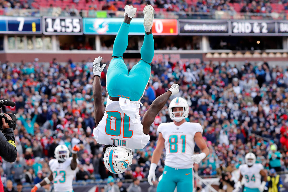 Miami Dolphins wide receiver Tyreek Hill (10) flips while celebrating after scoring a touchdown ...