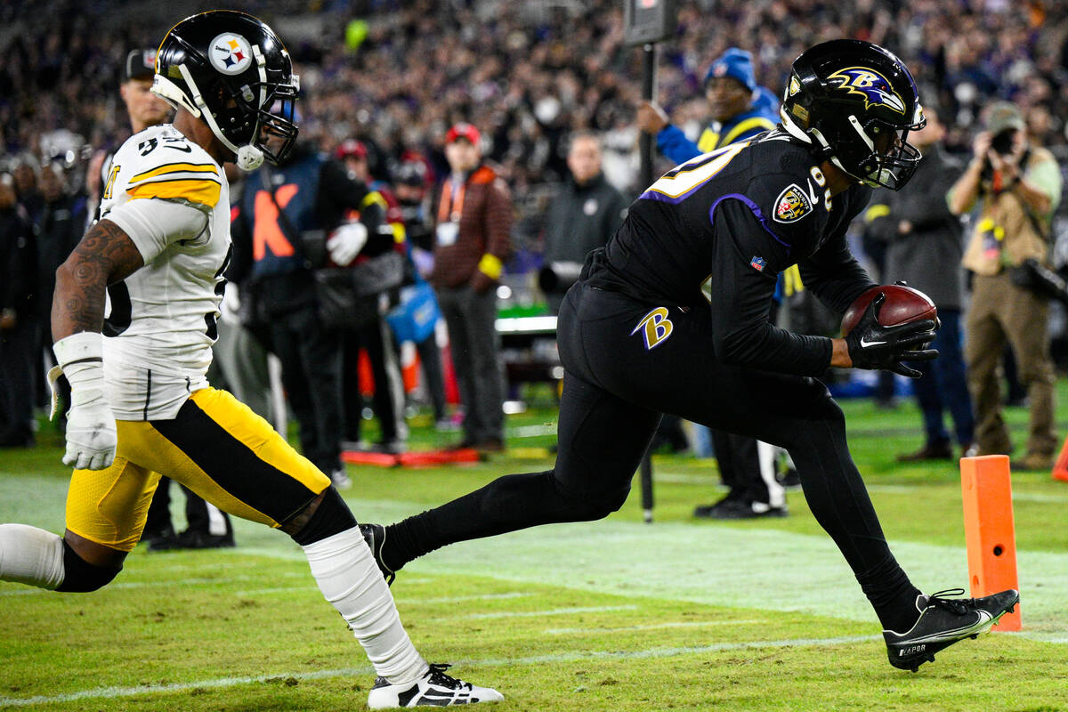 Baltimore Ravens tight end Isaiah Likely (80) makes catch in front of Pittsburgh Steelers corne ...