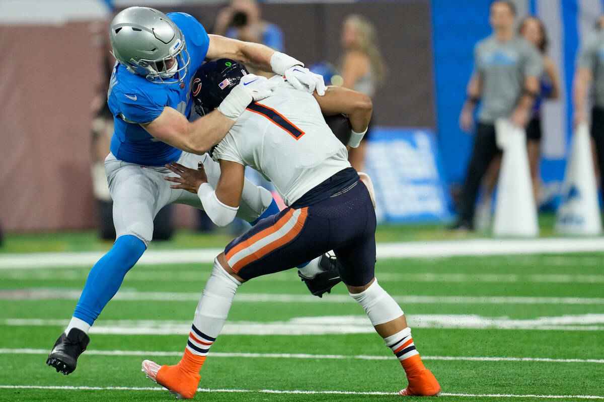 Detroit Lions defensive end Aidan Hutchinson tackles Chicago Bears quarterback Justin Fields (1 ...