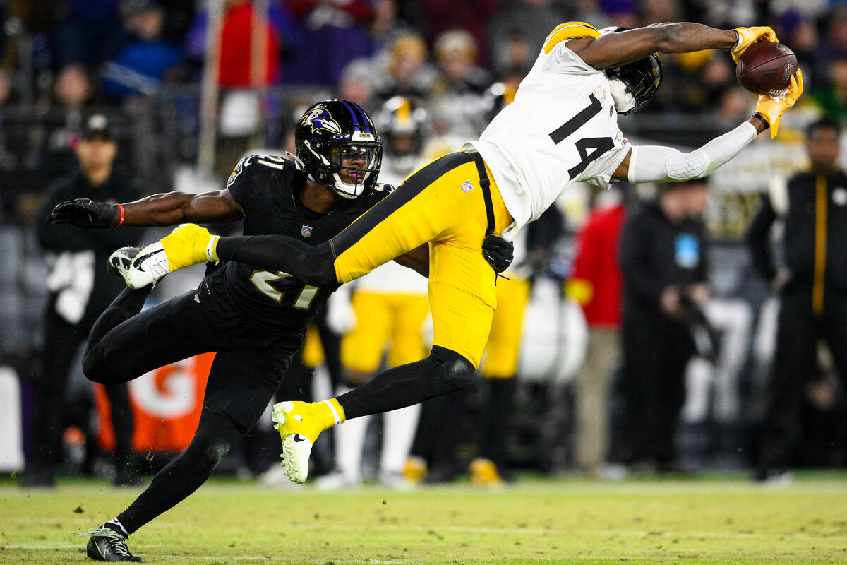 Pittsburgh Steelers wide receiver George Pickens (14) makes a catch in front of Baltimore Raven ...