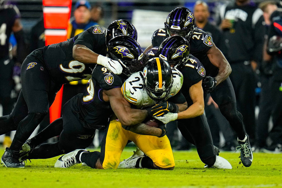Pittsburgh Steelers running back Najee Harris (22) is tackles by the Baltimore Ravens including ...