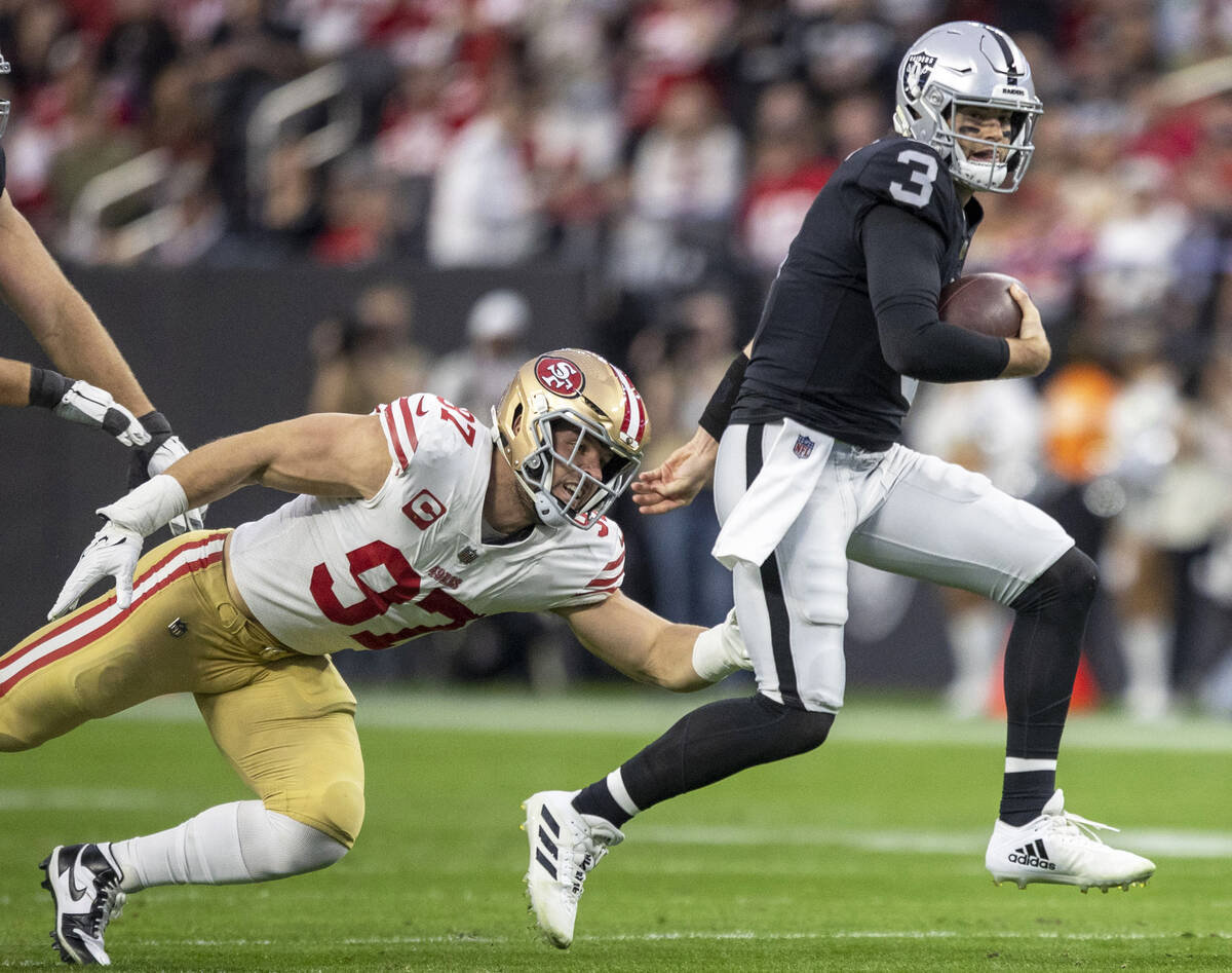 Raiders quarterback Jarrett Stidham (3) scrambles as San Francisco 49ers defensive end Nick Bos ...