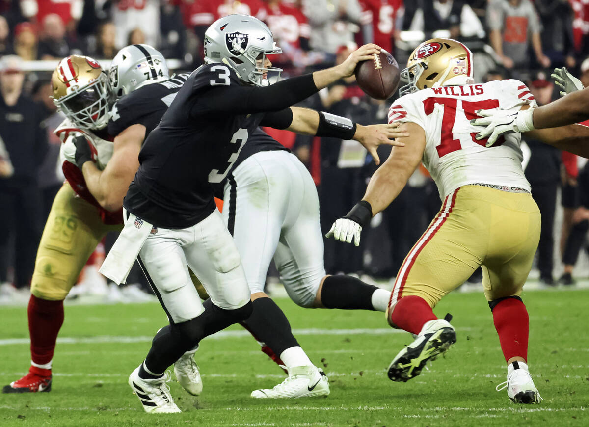 Raiders quarterback Jarrett Stidham (3) looks to pass under pressure from San Francisco 49ers d ...