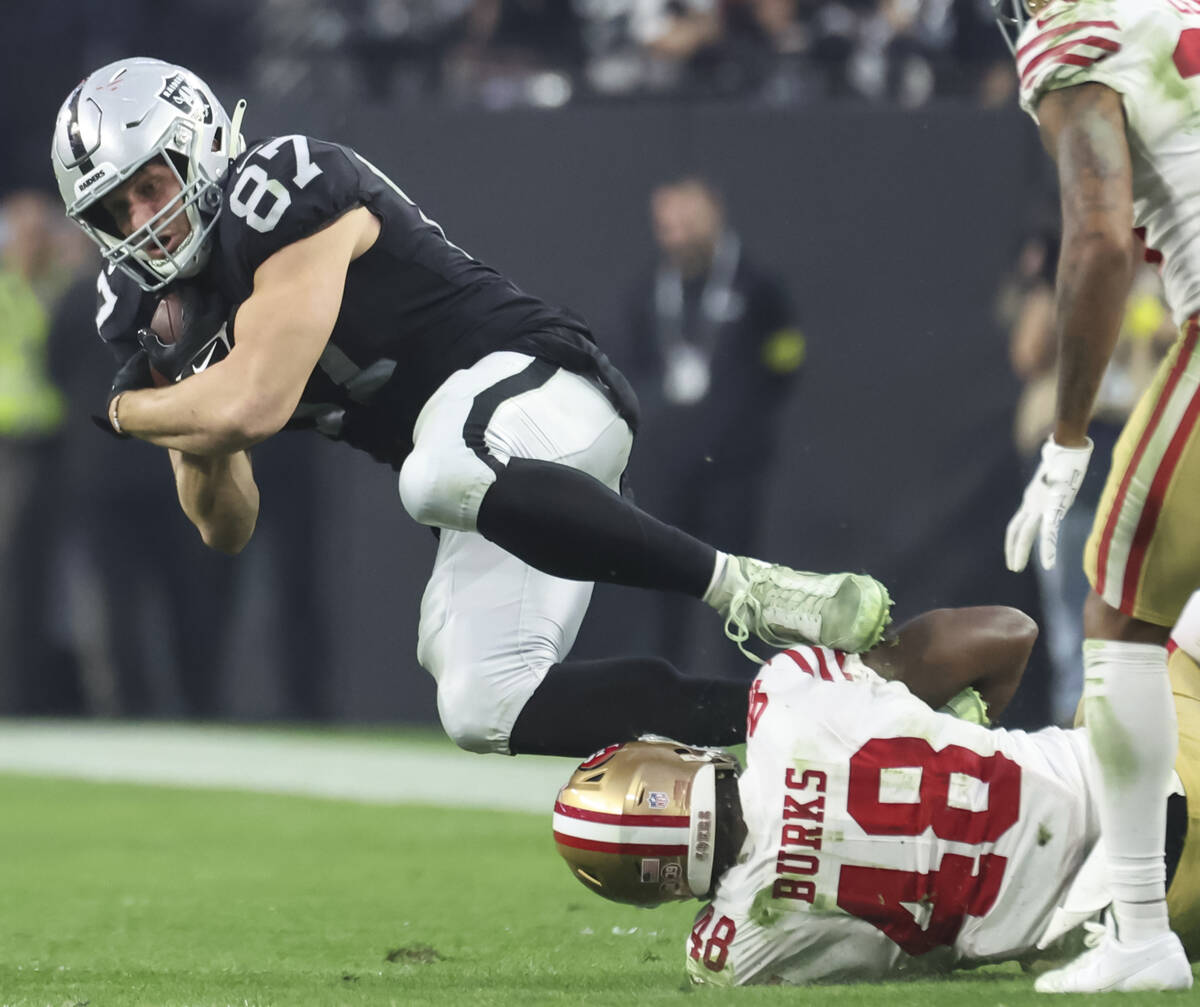 Raiders tight end Foster Moreau (87) gets tripped up by San Francisco 49ers cornerback Deommodo ...