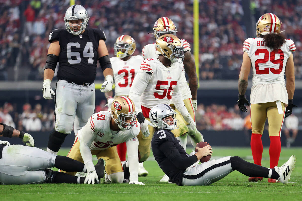 Raiders quarterback Jarrett Stidham (3) gets tackled by San Francisco 49ers defensive end Arik ...