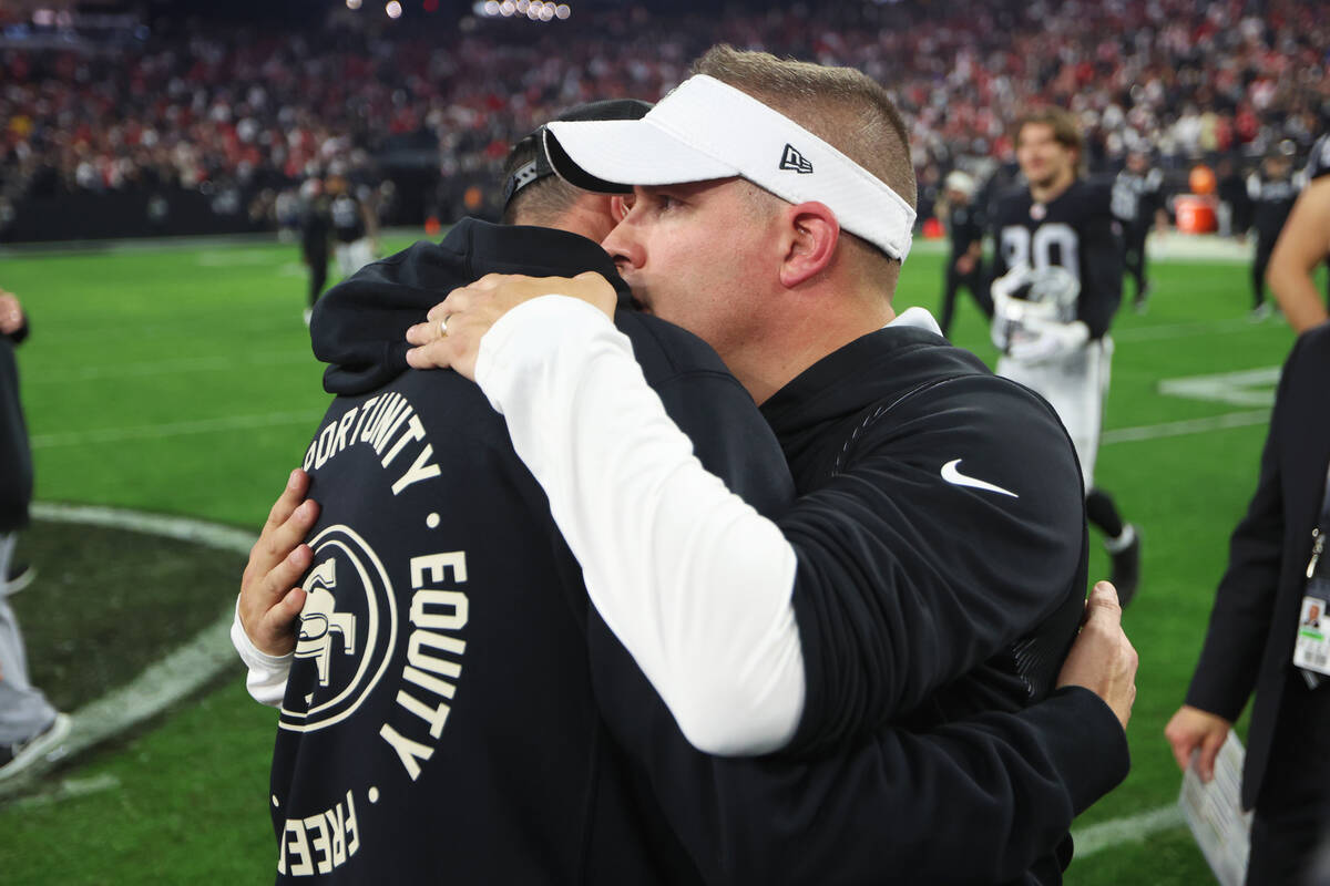 Raiders head coach Josh McDaniels, right, and San Francisco 49ers head coach Kyle Shanahan, emb ...
