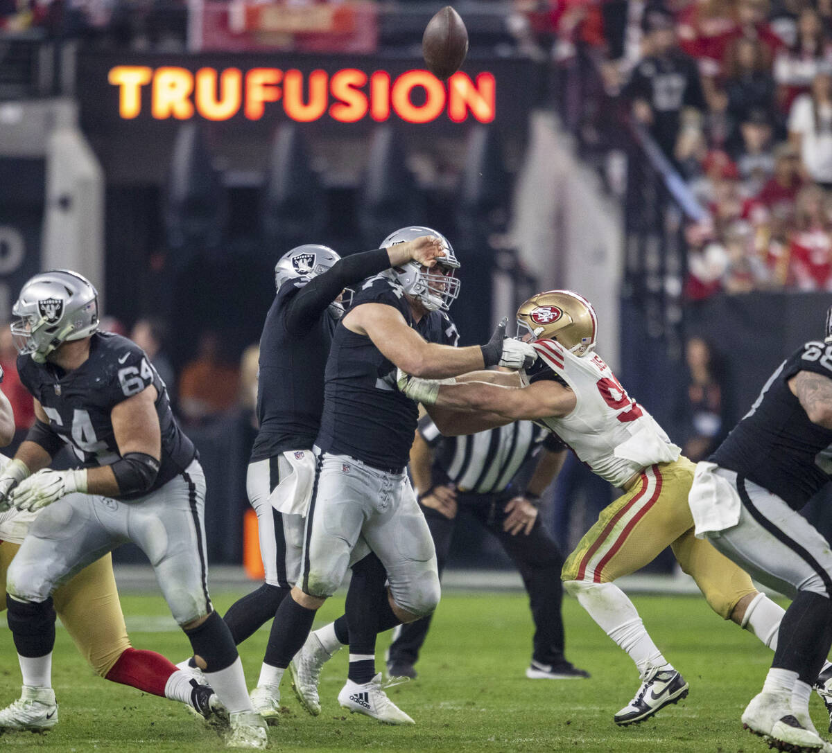 Raiders quarterback Jarrett Stidham (3) runs into offensive tackle Kolton Miller (74) as he tri ...