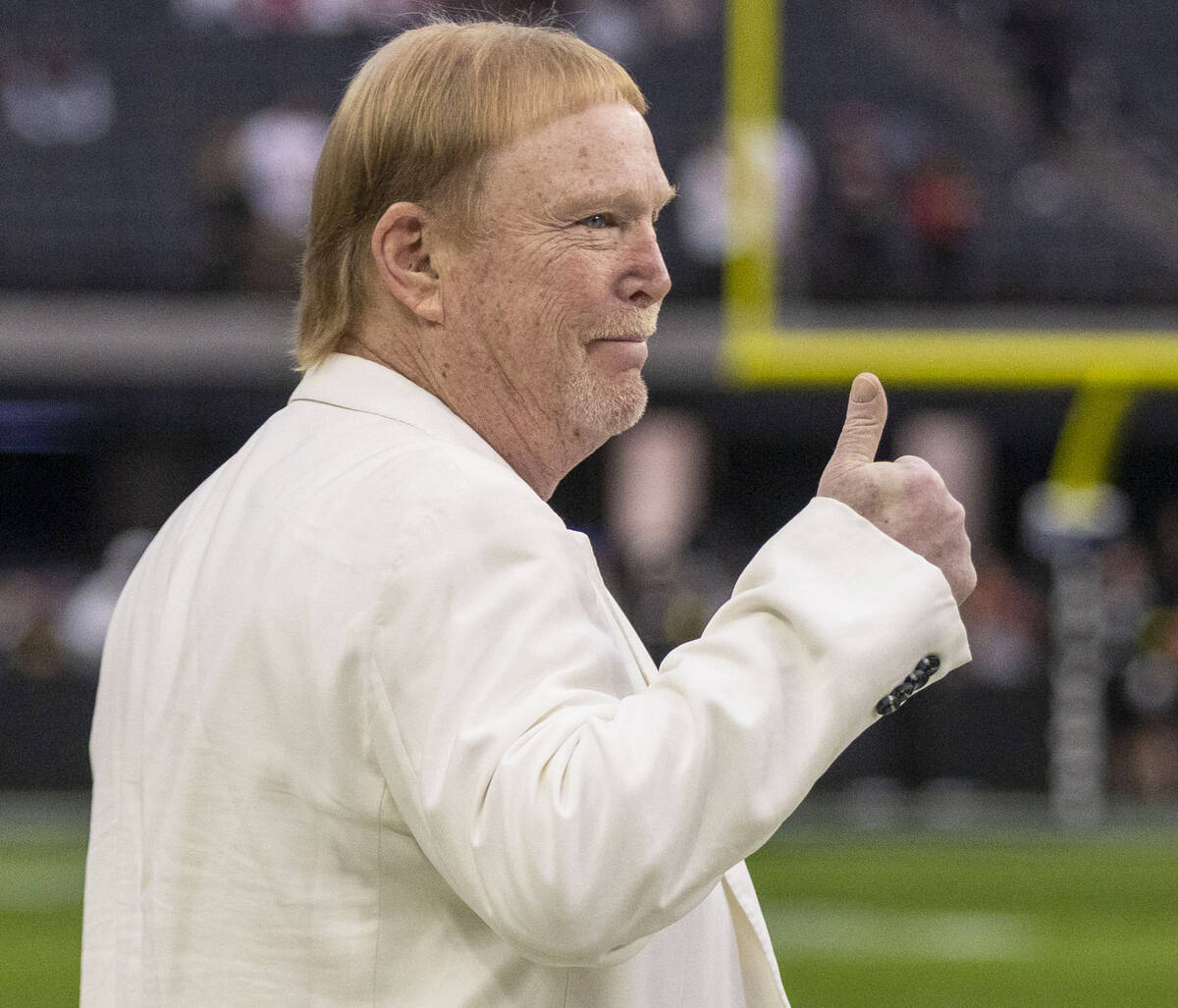 Raiders owner Mark Davis gives a thumbs up as the team warms up before an NFL game against the ...